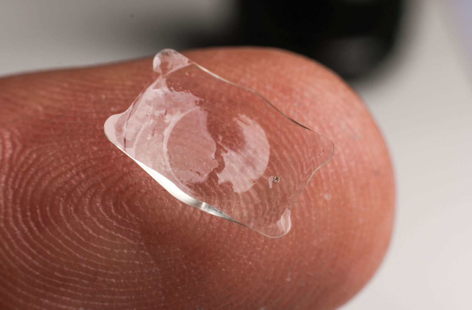 Phakic ICL lens placed on fingertip
